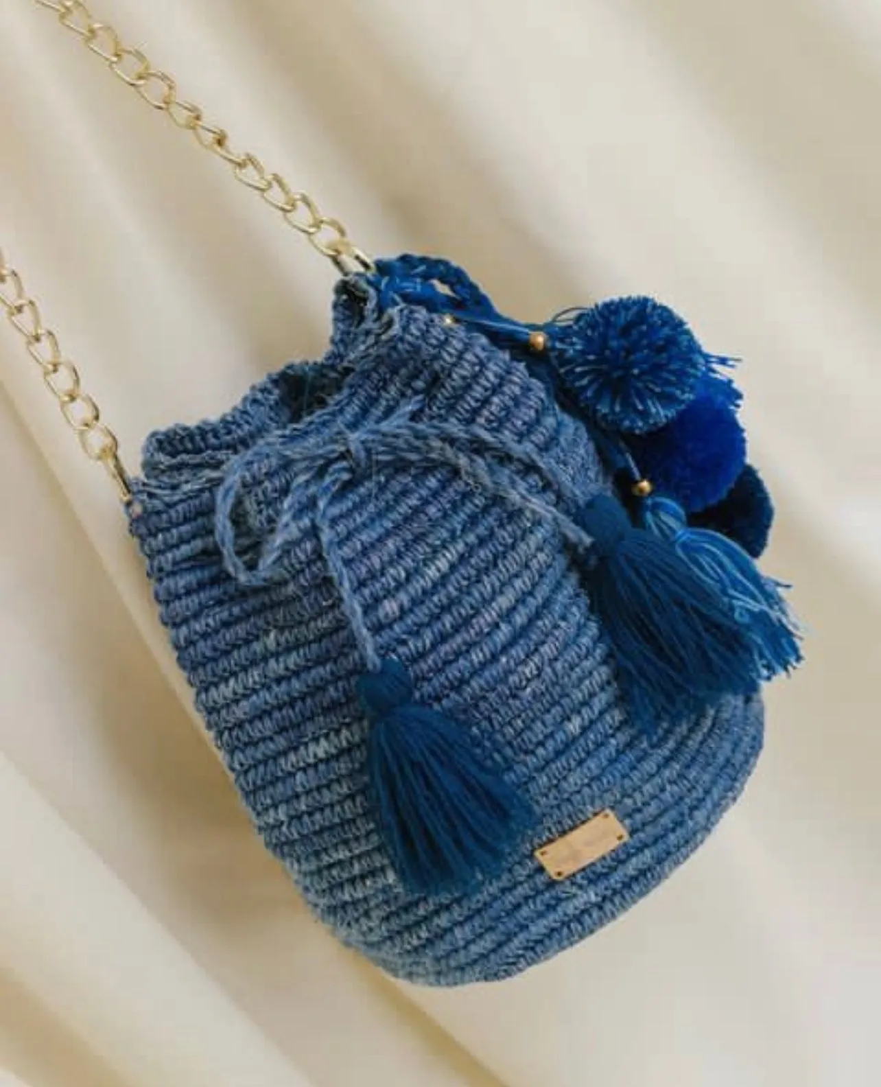 Bucket bag with Pom Poms